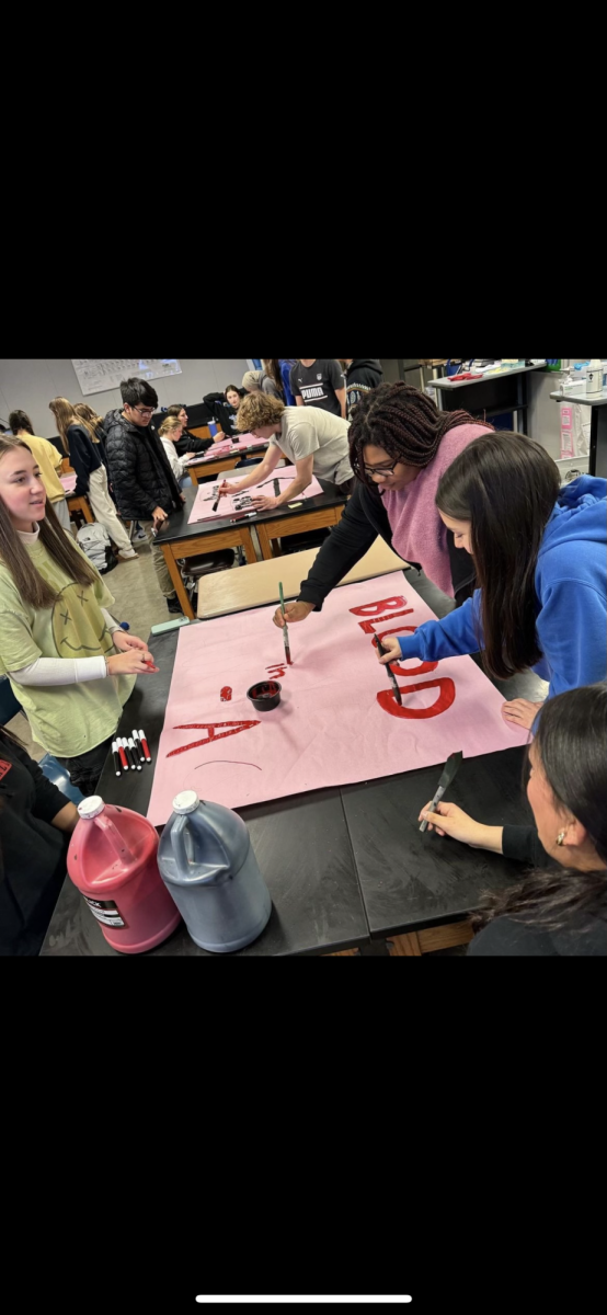 The Biomedical Club designing signs for their blood drive. 